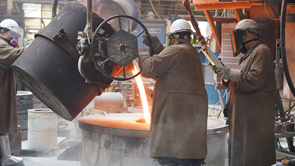 Johnson Centrifugal workers pouring copper for centrifugal casting
